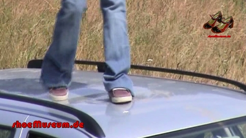 A young woman walks on a car - part A (0004A)